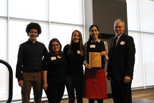 Five staff and volunteers representing the Cleaver Family YMCA Togetherhood program hold the award plaque they received from the Southtown Council for volunteer service.