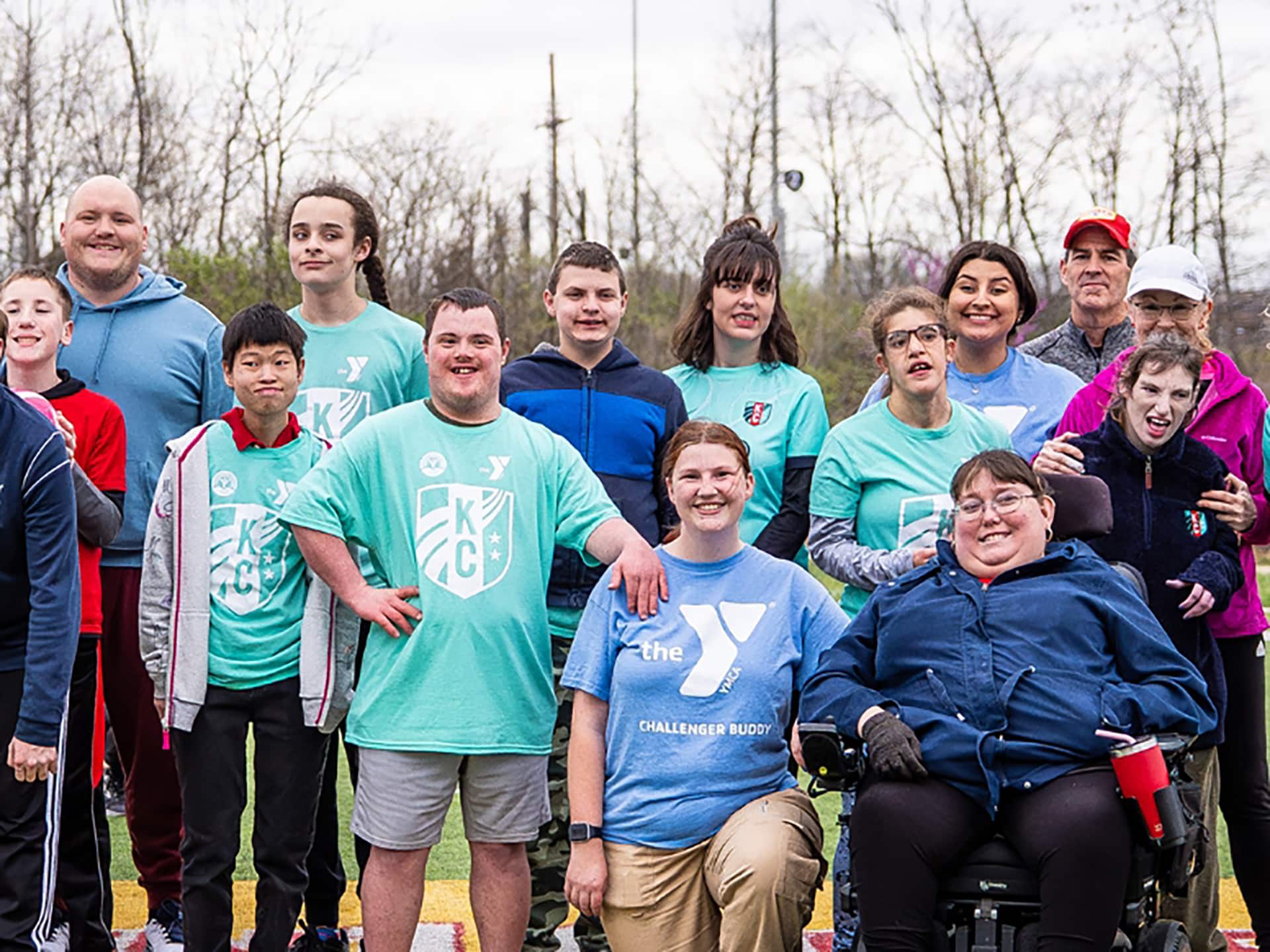 YMCA Challenger adaptive sports group posing outdoors in the spring