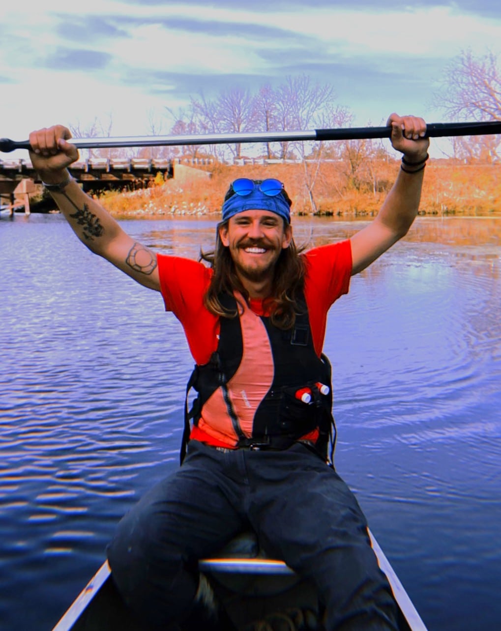 Portrait of Erik Maas, Olathe YMCA team member, paddling a canoe on a river
