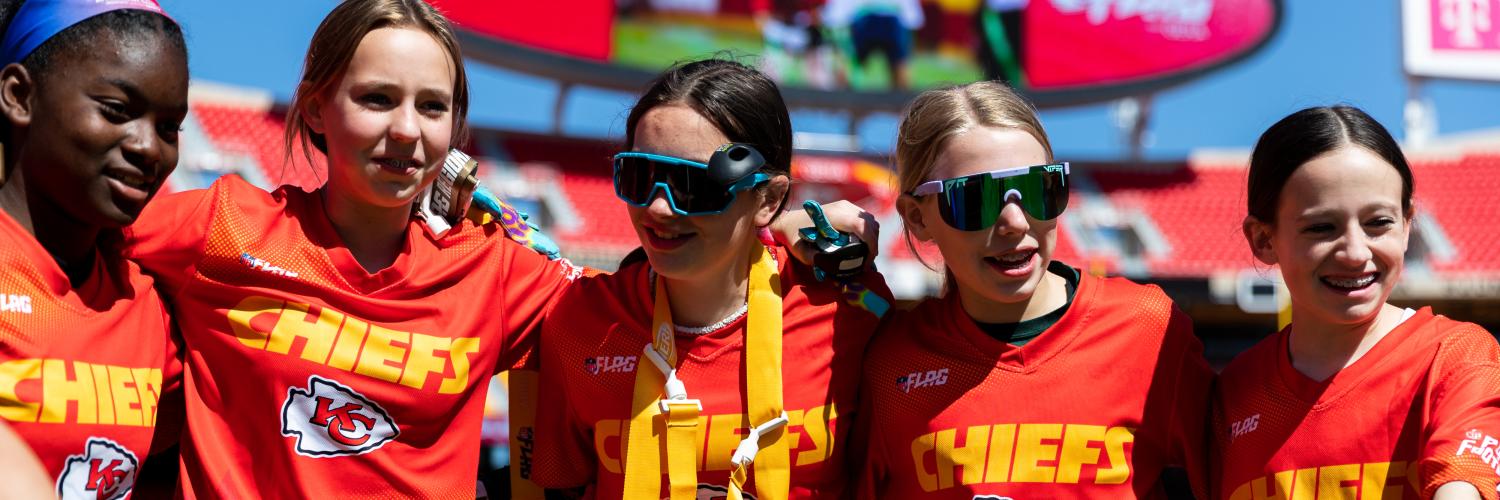 YMCA Flag Football Players pose for photo on GEHA field at Arrowhead.