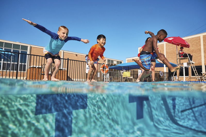 boys jumping in pool