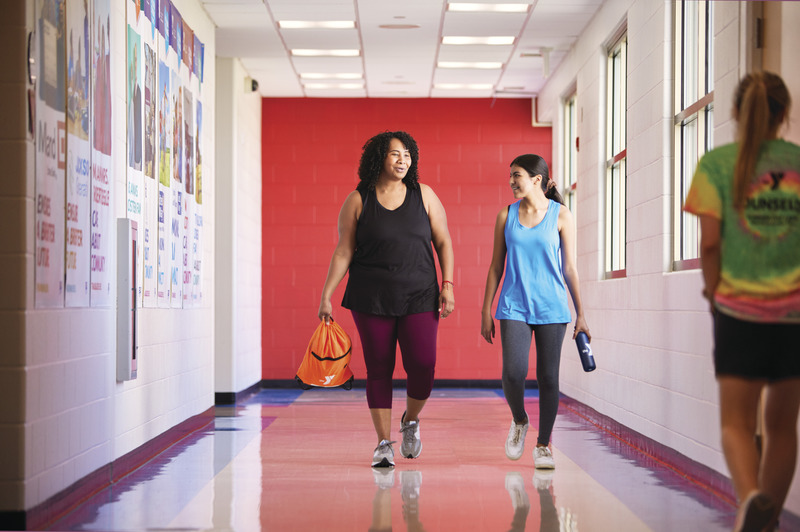 women walking down hallway to fitness class at the y