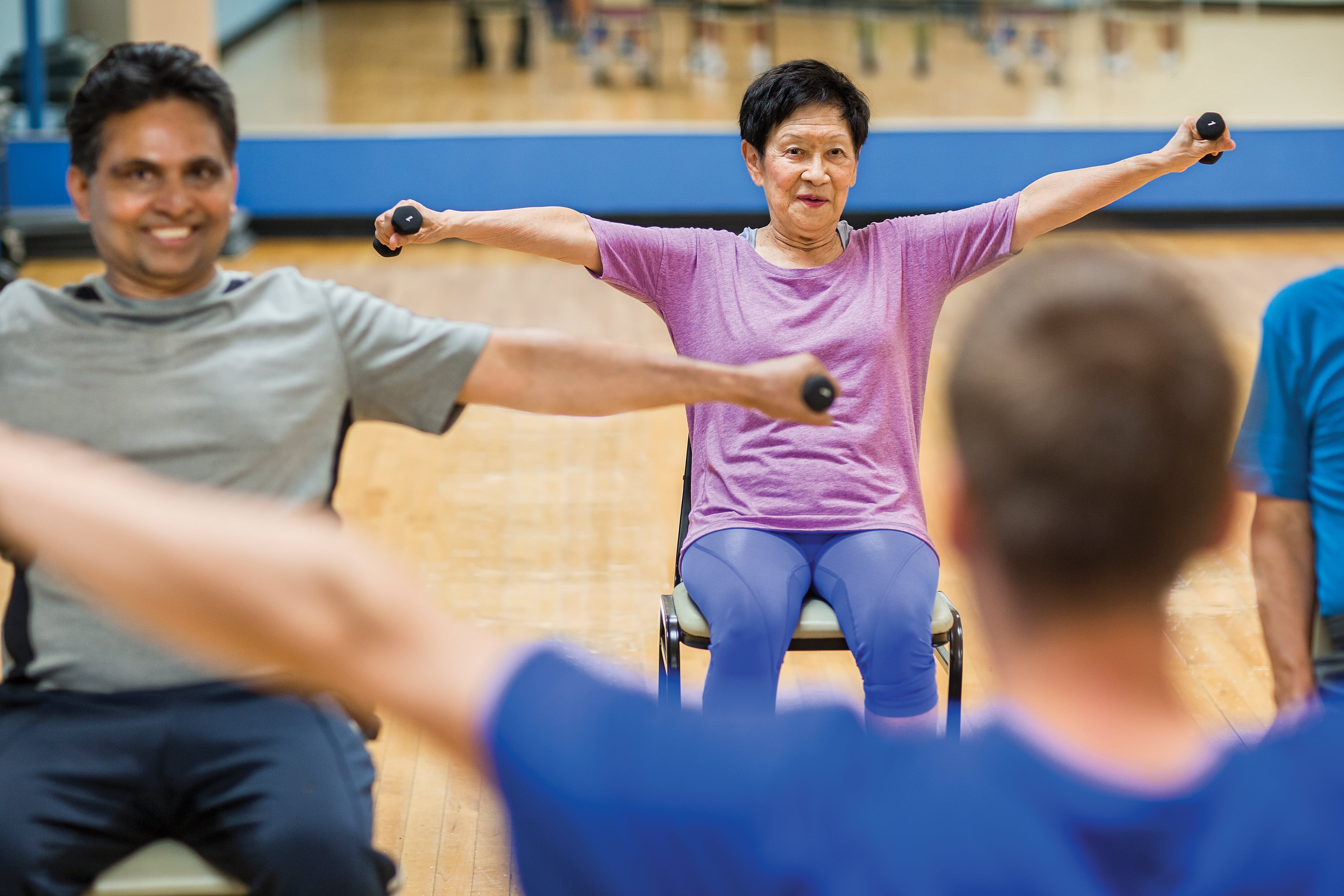 YMCA members in a seated weight lifting class at the Kansas City YMCA