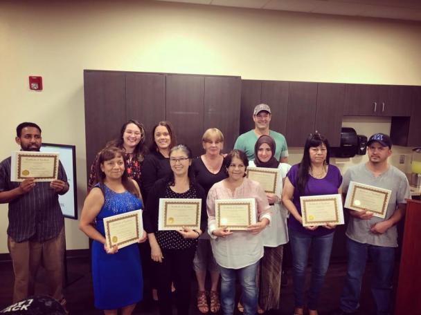 Photo of group of English as a Second Language participants, holding their certificates for completing the course.