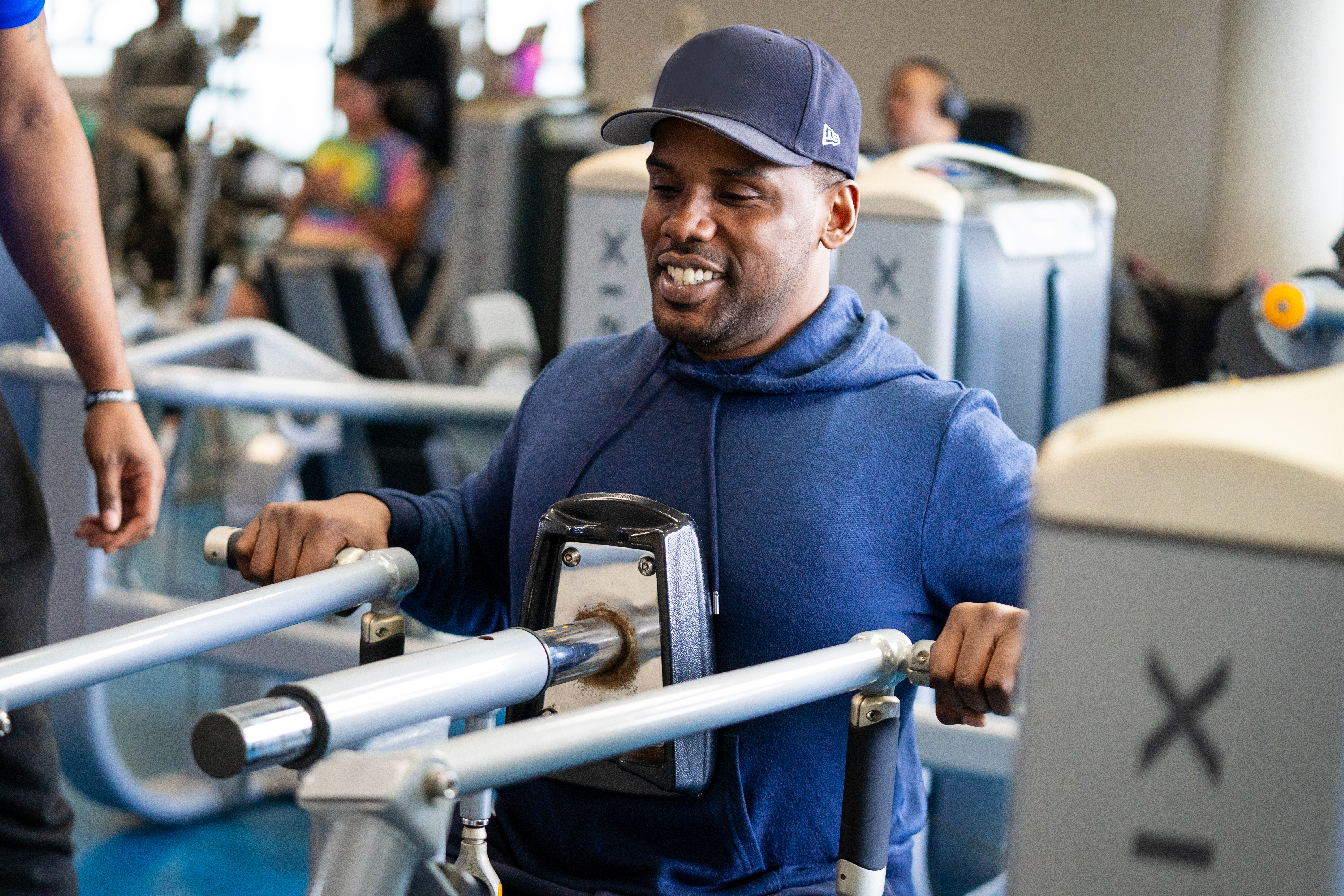 Photo of man working out at a machine and smiling