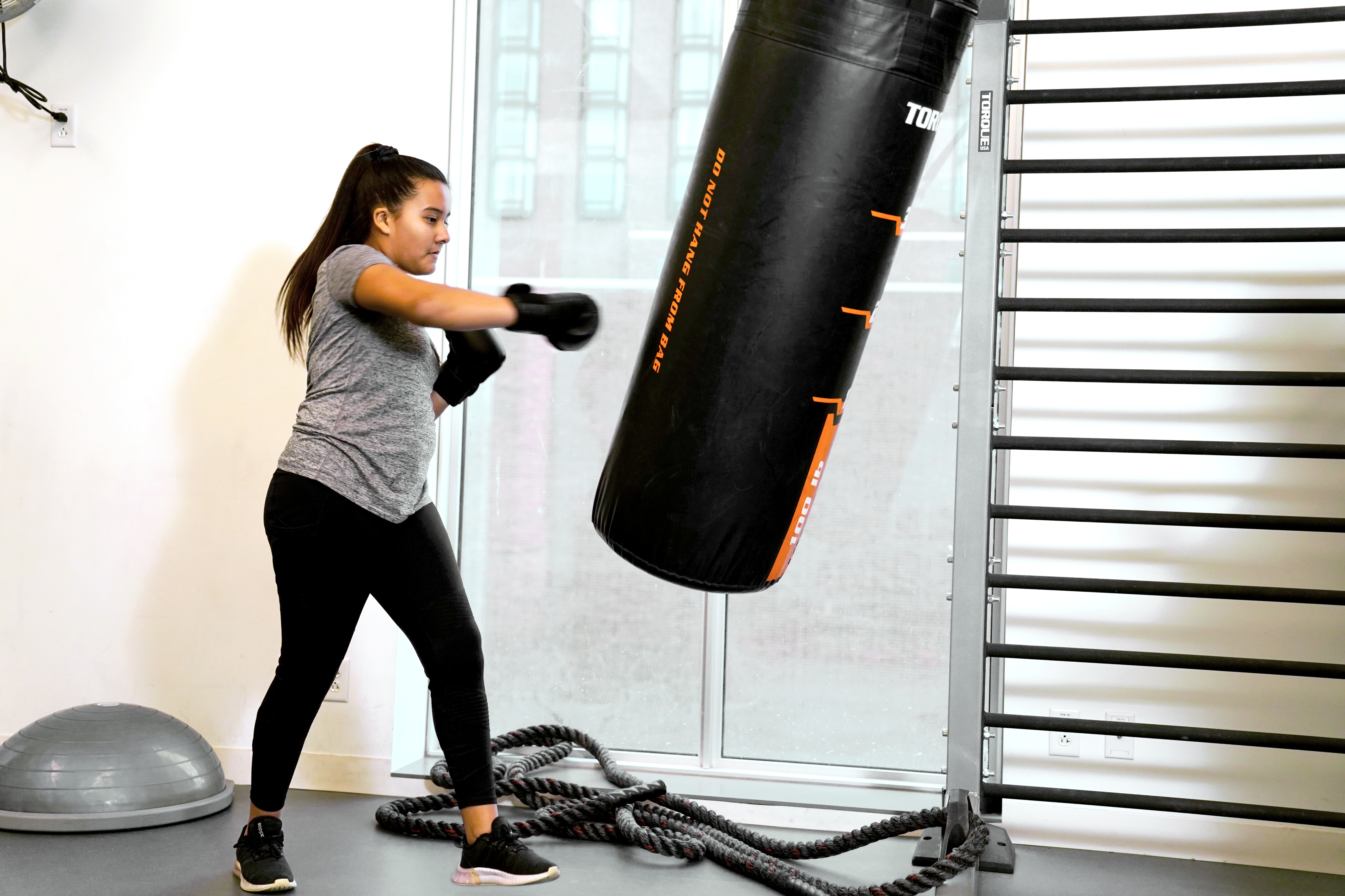 Photo of a woman using a punching ball 