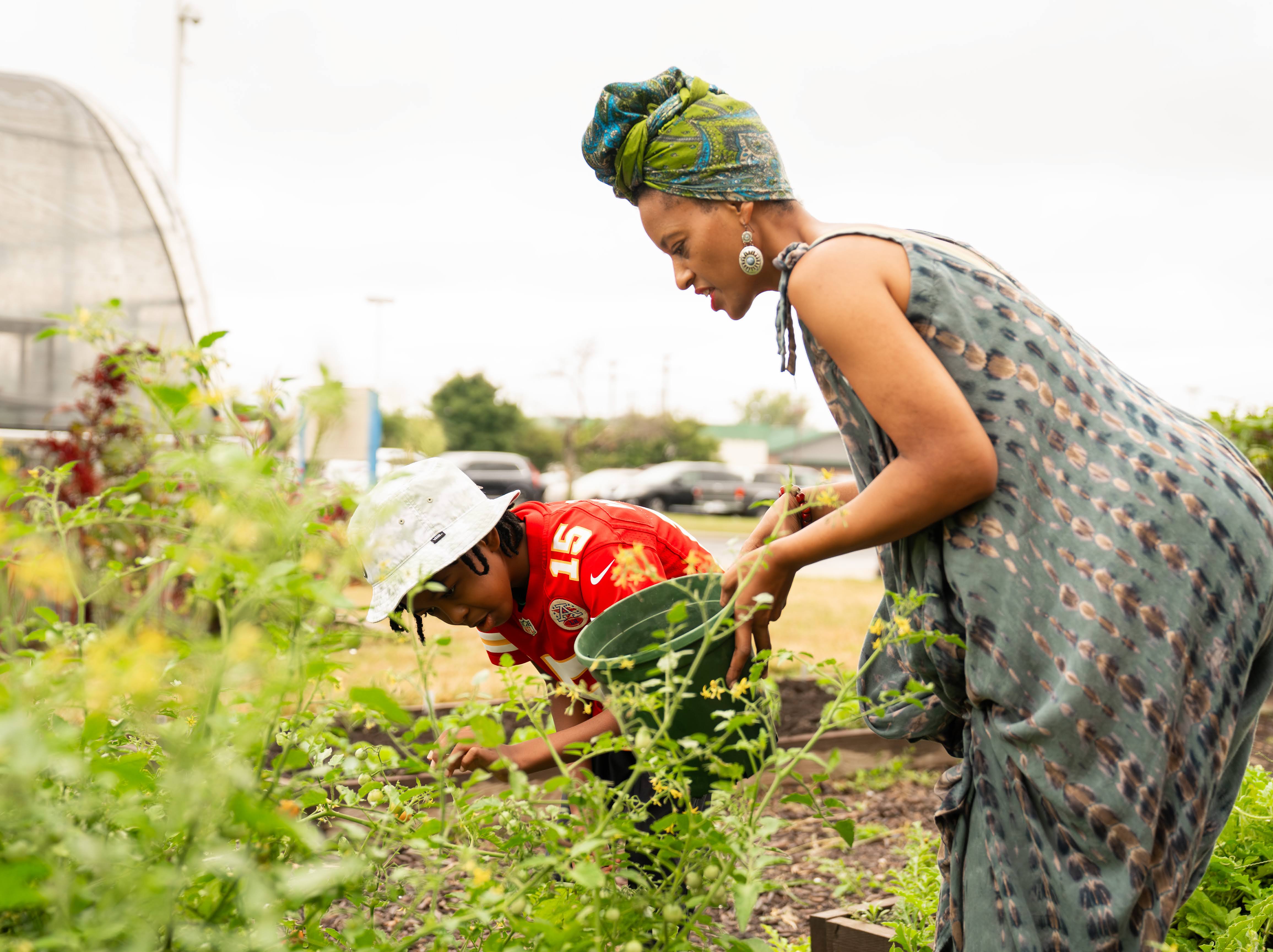 Photo of an adult and a child gardening together