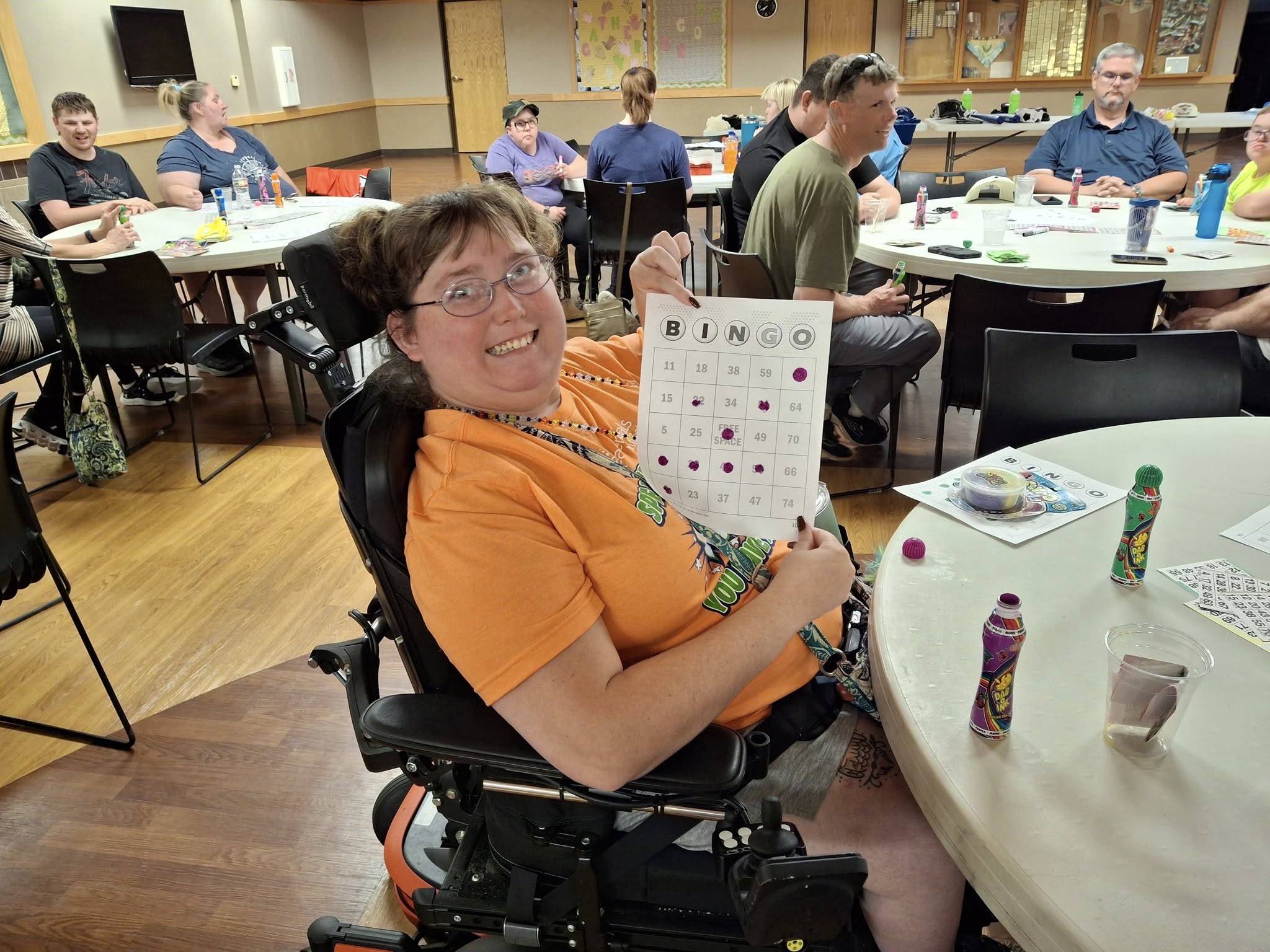 Challenger Participant showing bingo card during a young social event.