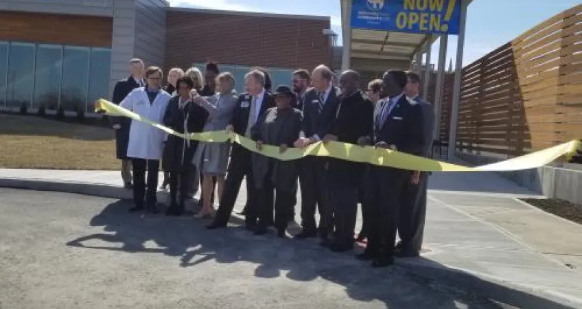 Leaders from University Health/Truman Medical and the YMCA of Greater Kansas City gather outside new medical center for a ribbon cutting.