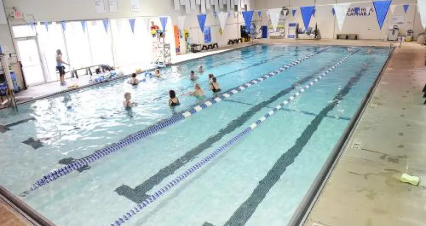 Angled view of an indoor pool with swimming lanes. 