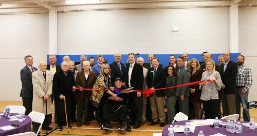 A group of donors and Y leaders pose before the ribbon cutting inside the new community center.