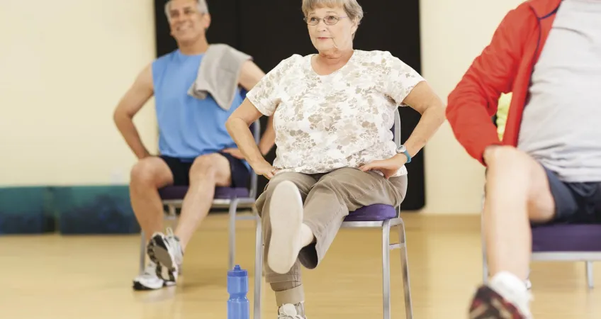 Active Older Adults performing active fall prevention exercises in Kansas City YMCA group class.