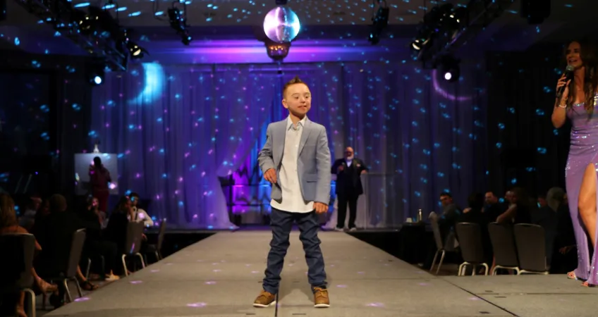 Challenger athlete Bennett Fischer on the runway at the 16th Annual Challenge Your Fashion presented by Pro Athlete.