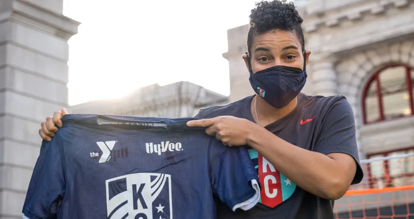 KC Current Goalkeeper Adrianna Franch holds the YMCA KC Current youth soccer jersey.