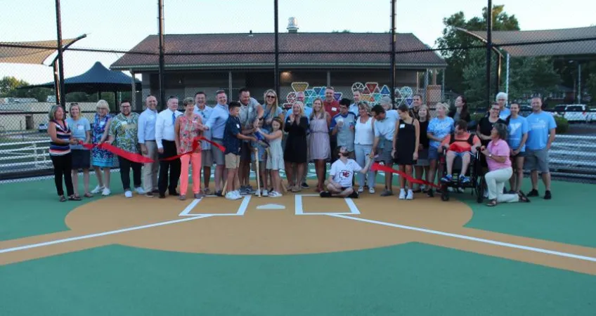 Teahen family celebrates the rededication with a ribbon cutting.