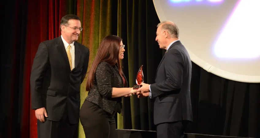 John Passanisi, Chief Volunteer Officer, and John Mikos, Greater Kansas City YMCA President and CEO, handing awards to volunteer award recipient.