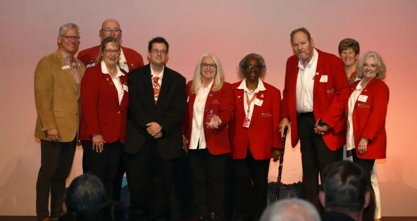 The Kansas City Chiefs Red Coaters accept an award on stage at the 2023 Spirit of Service Awards.