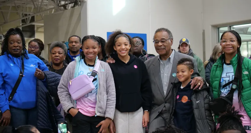 A group of volunteers of all ages at the MLK Day of Service event stand and smiles with Congressman Emanuel Cleaver.