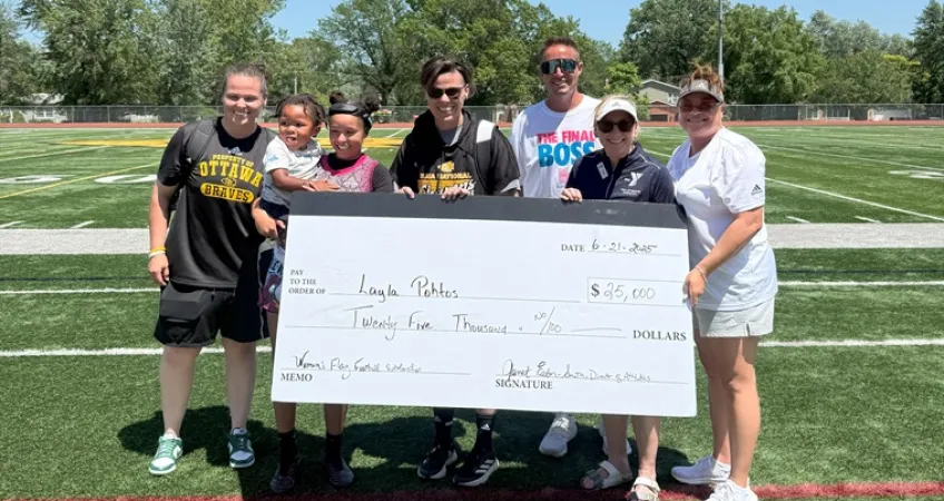 Photo of Ottawa MVP Layla Pohtos with representatives from Ottawa University and the YMCA of Greater Kansas City, holding an oversized check for her scholarship of $25,000