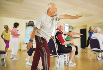 Active older Kansas City YMCA members exercising in a Kansas City YMCA class.