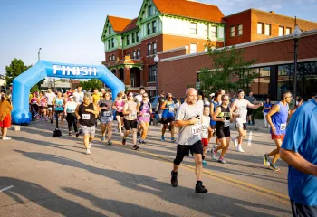Runners cross the finish line of the Amelia Earhart Run in front of the Atchison Family YMCA/Cray Community Center