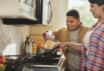Mother and son cooking