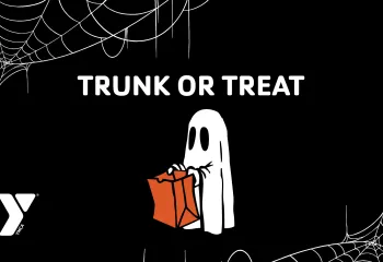 Illustration with cobwebs and child wearing a ghost costume holding a bag for trick or treating, Y logo and headline "Trunk or Treat."