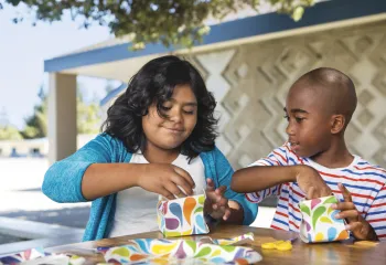 Two kids working together on a craft project