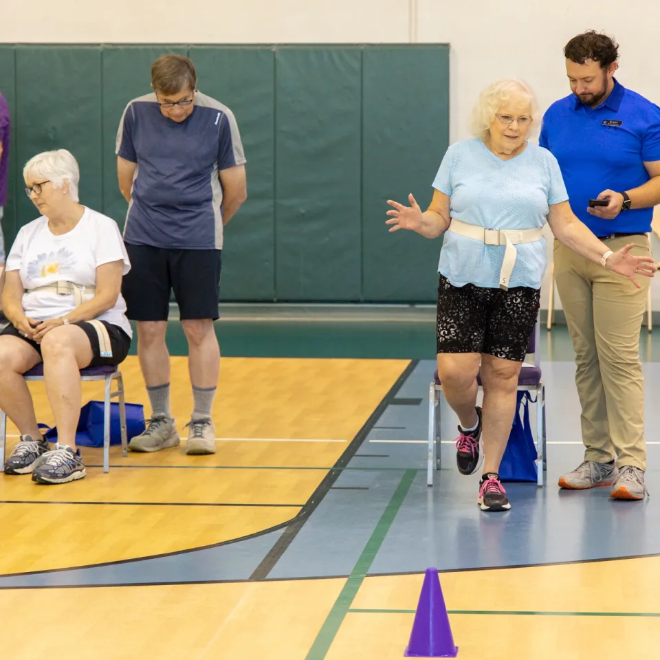 YMCA active older adults exercising and learning fall prevention techniques from Kansas City YMCA staff at Healthy Living Fall Prevention Fair.