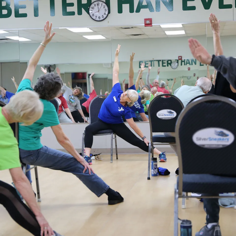 Older adults seated and stretching in Active Older Adults Group Exercise Class.