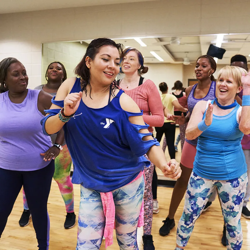 Group of people dancing in a YMCA class