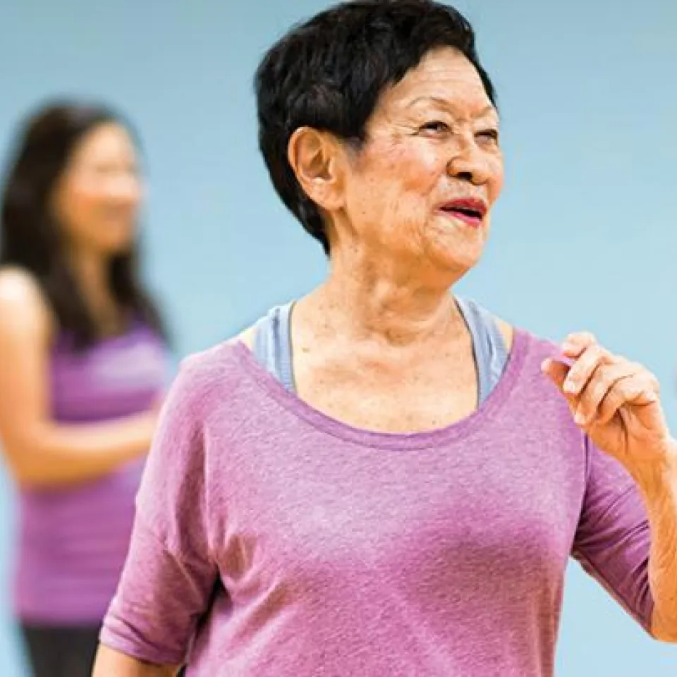 Active Older Adult woman exercising in a YMCA Aerobics Class.