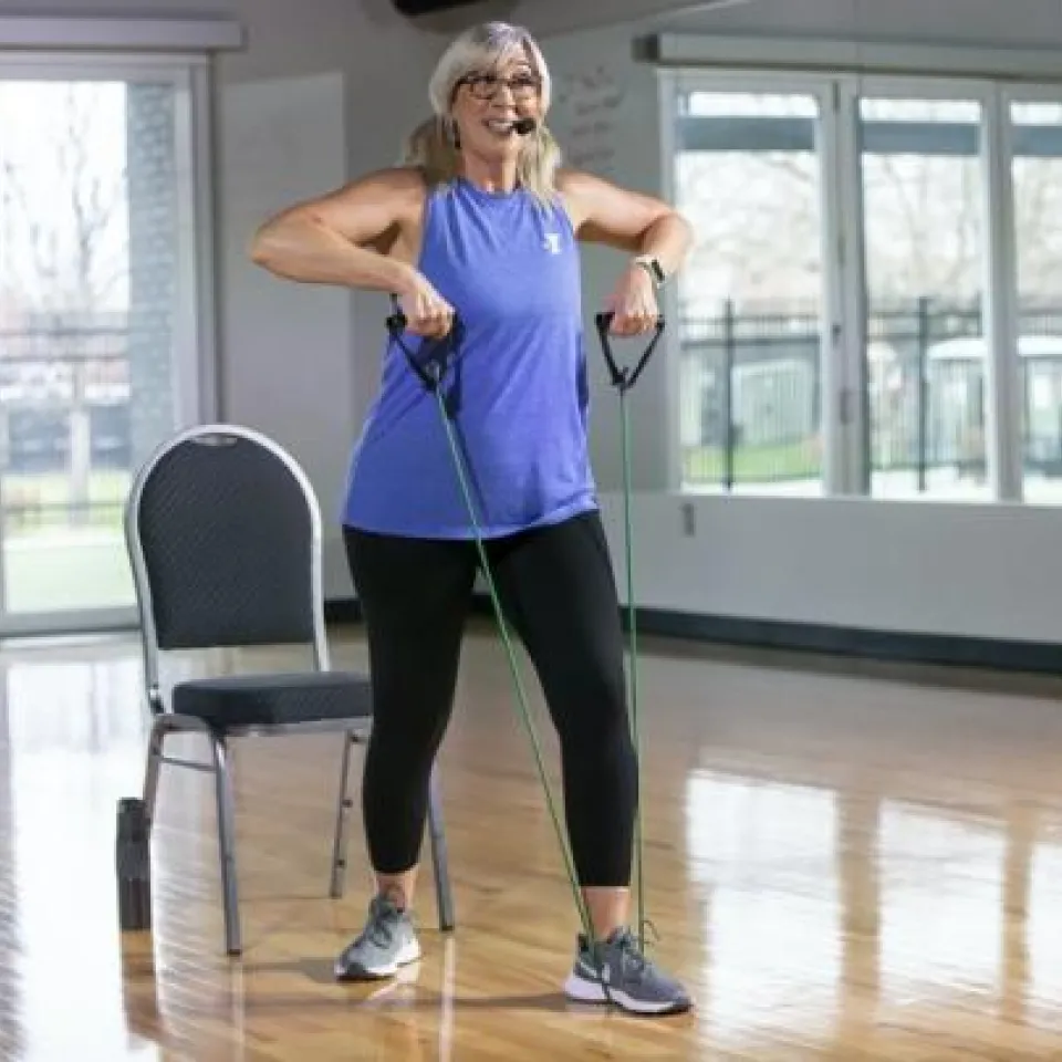 Active Older Adults working out with resistance band.