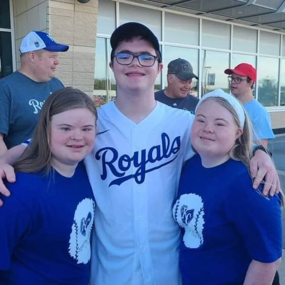 Three YMCA Challenger Athletes smiling at Kauffman Stadium