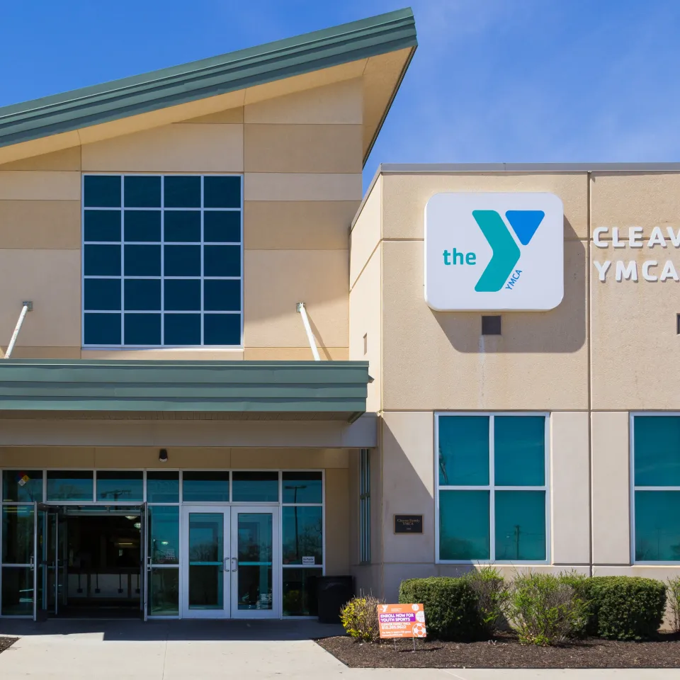 Exterior image of Cleaver Family YMCA, showing entrance and logo signage on the building