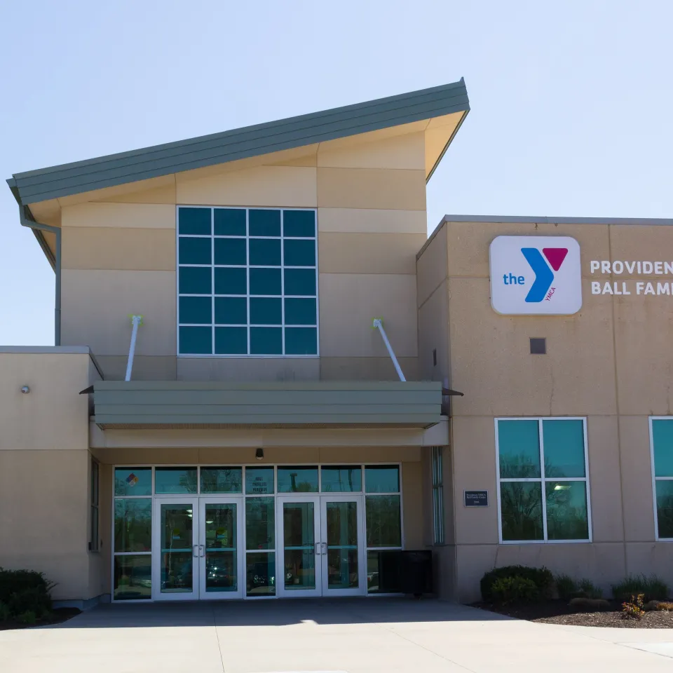 Exterior photo of Providence YMCA/Ball Family Center, showing Y logo on the building and American flag on flagpole.