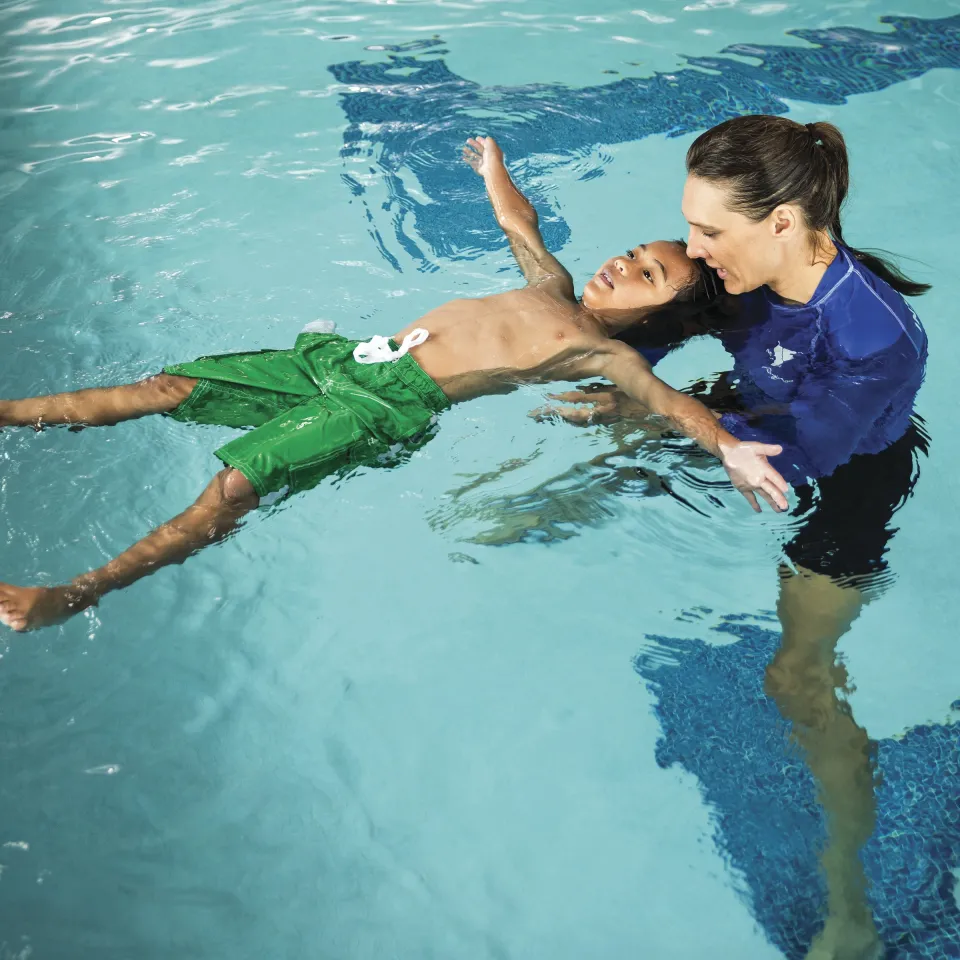 YMCA swim teacher and child