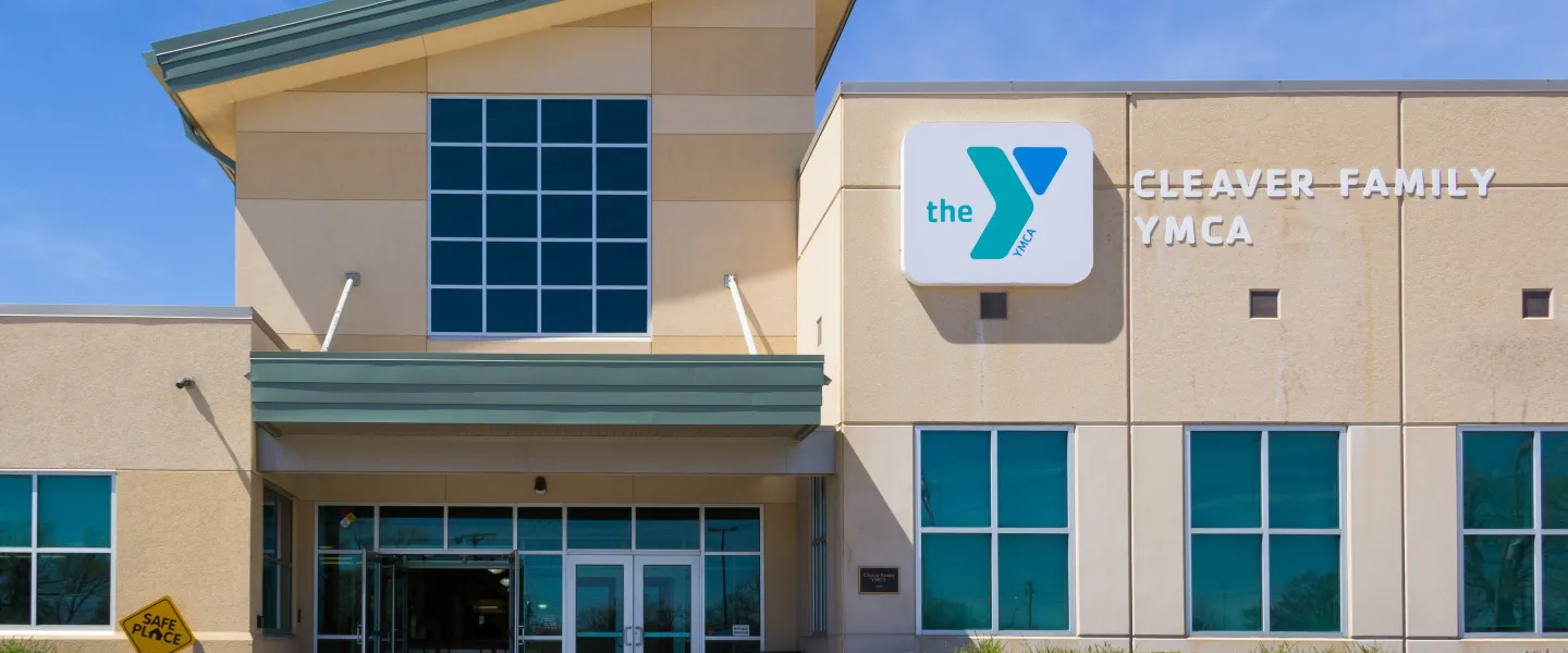 Exterior image of Cleaver Family YMCA, showing entrance and logo signage on the building