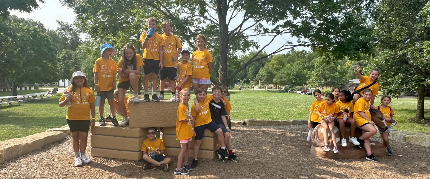 Photo of groups of campers on standing on large blocks at park