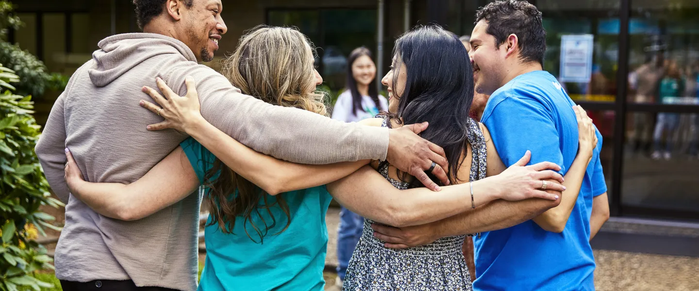Photo of YMCA members hugging and smiling