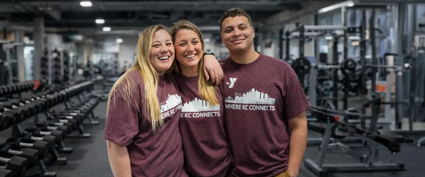 Photo of three members on wellness floor wearing limited edition "Where KC Connects" t-shirt