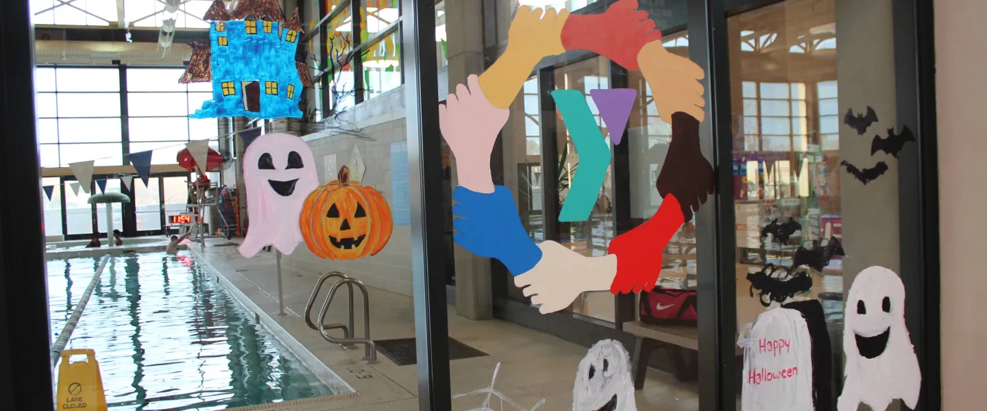 Happy Halloween written on the pool window 