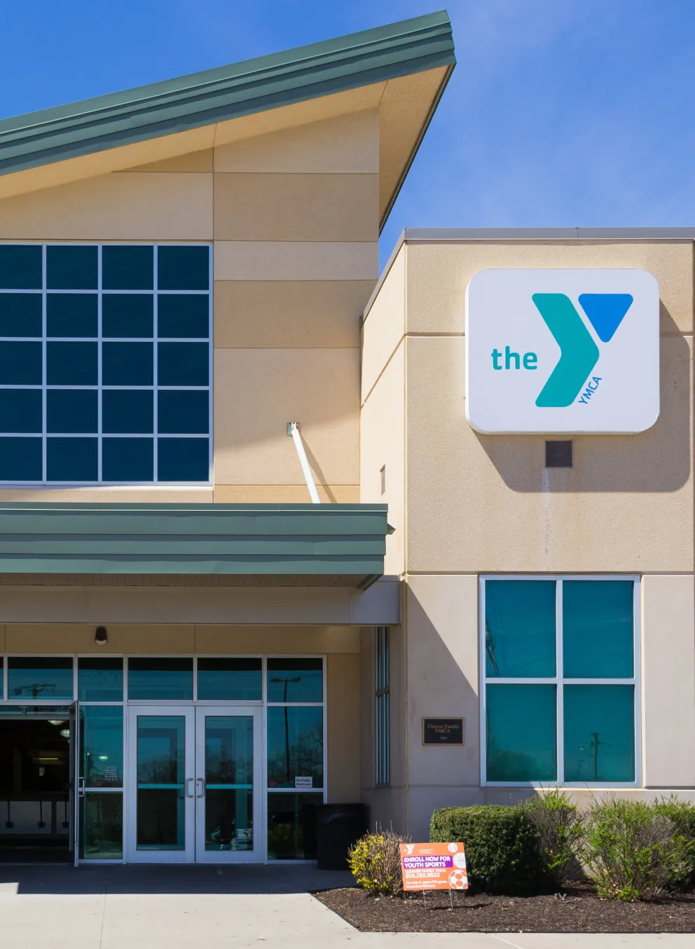 Exterior image of Cleaver Family YMCA, showing entrance and logo signage on the building