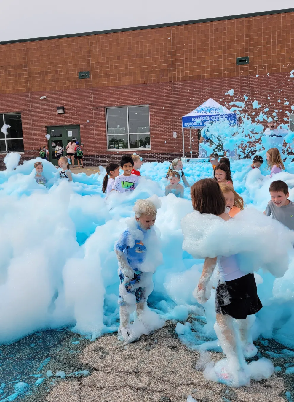 Kids play in blue foam at summer day camp