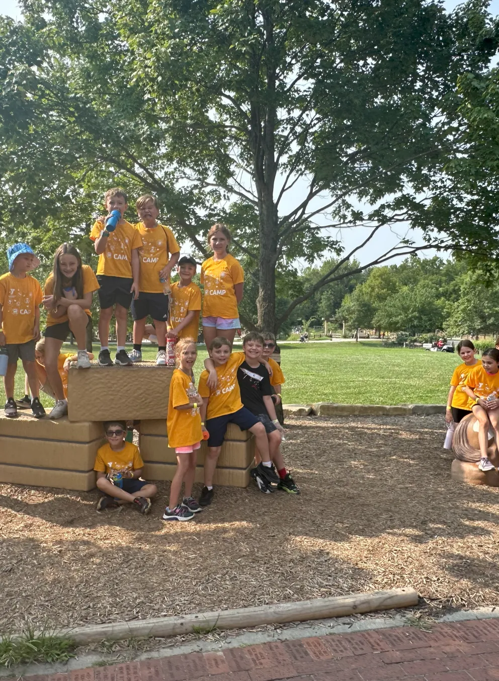 Photo of groups of campers on standing on large blocks at park