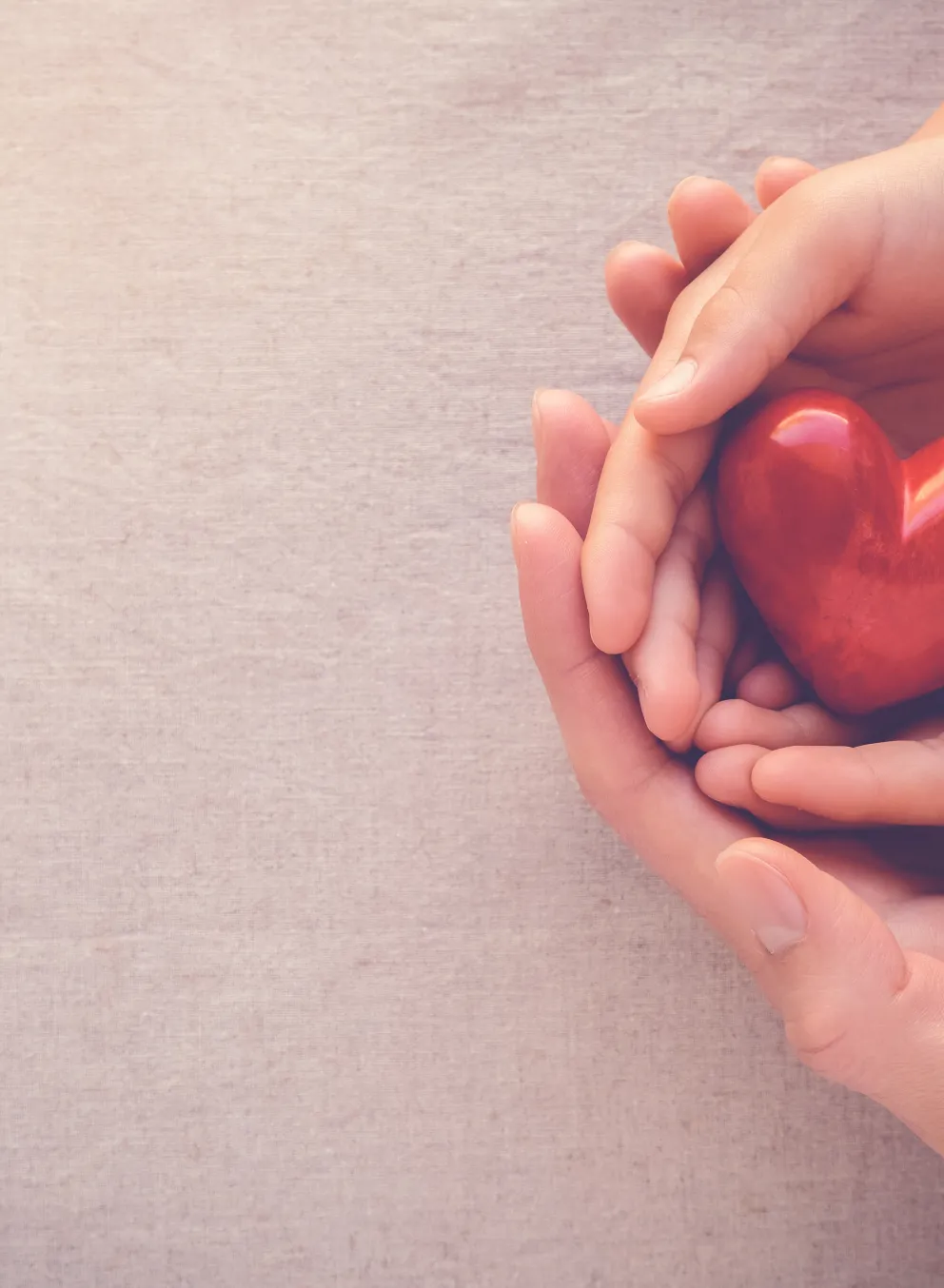 Photo of two people holding a heart-shaped object