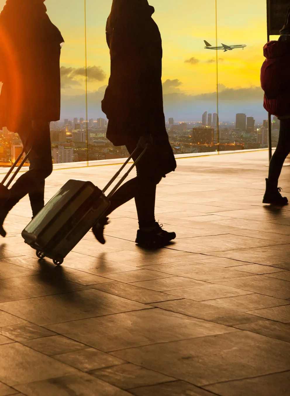Photo of people walking with suitcases.