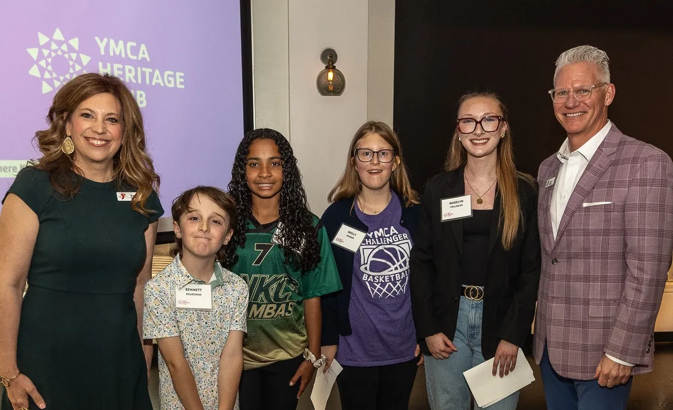 Photo of SVP of Youth Development Darcy Swan, youth program participants, and CEO Mark Hulet