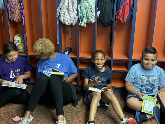 SPARK! students reading and smiling