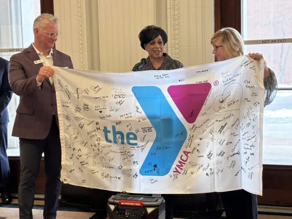 Photo of flag signed by YMCA volunteers for the time capsule.